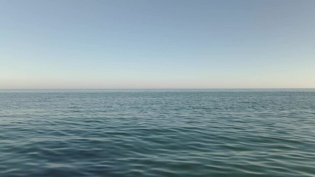 Vast huge open ocean seascape blue water calm wave surface looking out to horizon