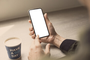 cell phone mockup image blank white screen.woman hand holding texting using mobile on desk at coffee shop.background empty space for advertise.work people contact marketing business,technology