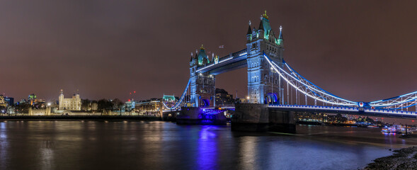 Obraz na płótnie Canvas Panorama of city skyline at night with Tower Bridge and Tower of London in London England