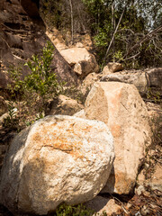Obraz premium Natural background. Closeup edged shabby cliff cracks. Gray-brown stone rock texture of mountains. Vintage and faded matt style colour in tinted photo. Concept of geolog, mountaineering or hard work