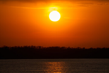 Big Sun on sunset over the river