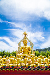 Row of disciple statues surrounding big buddha statue.