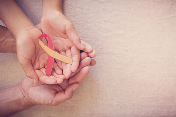 Adult and child holding red and yellow ribbon, World hepatitis day concept