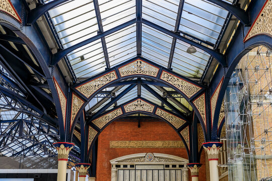 Intricate wrought iron decorative roof trusses details at the Liverpool Train Station in London, United Kingdom