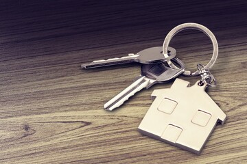 House keys with house figure on desk