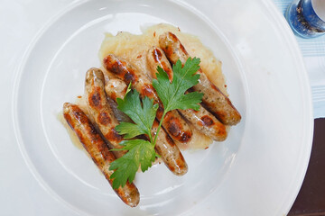 traditional bavaria Munich Germany grilled Sausage called Rostbratwurst or grill sausages served on white plate dish in local restaurant