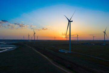 Wind turbine at beautiful orange red sunset