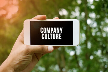 COMPANY CULTURE word on smartphone with bokeh in background