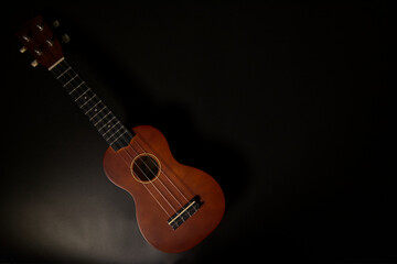 Naklejka premium Beautiful Ukulele on black background