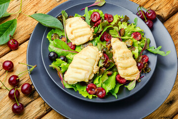 Spring salad with fried cheese and cherry