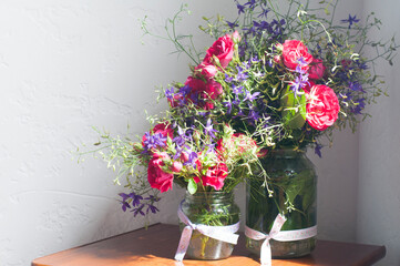 Bouquet of pink flowers in a vase. On the table. Spring and summer flowers. Still life