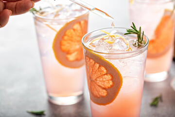 Grapefruit cocktail with rosemary with bitters in a drop