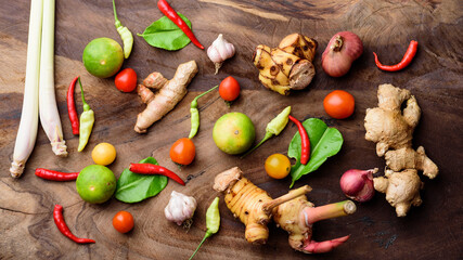 Thai food ingredients, spices and herbs for cooking on wooden background, organic vegetables	