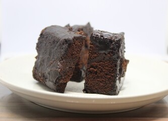 Black forest cake on a white plate.
Delicious black forest created manually.