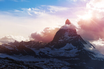 Matterhorn peak covering by cloud on evening with sunset vanilla sky