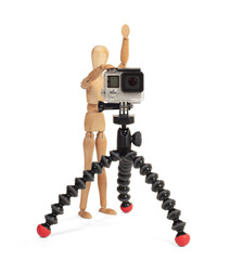 Wooden dummy standing trying to make a video or photo