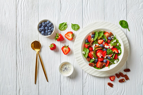 berry spinach salad with nuts and crumbled feta