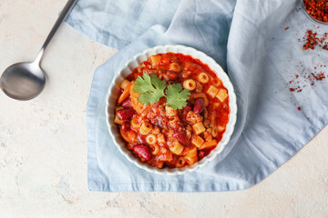 Bowl with tasty pasta and beans on table