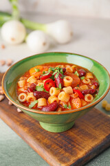 Bowl with tasty pasta and beans on table