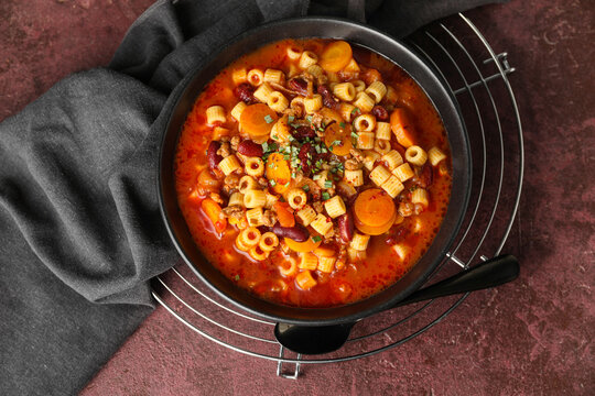 Bowl with tasty pasta and beans on table