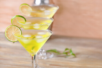 Glasses of tasty martini cocktail on table, closeup