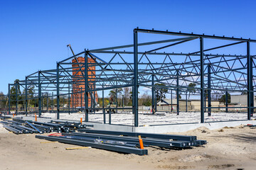 Fototapeta na wymiar Structure of steel for building construction on blue sky background.