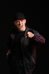 Aggressive police officer on dark background