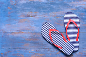 Stylish flip-flops on wooden background