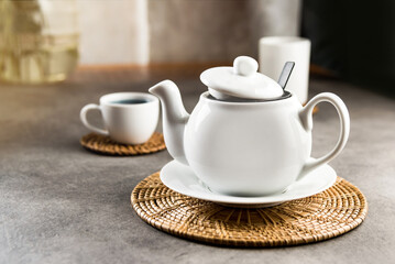 White porcelain teacup and teapot