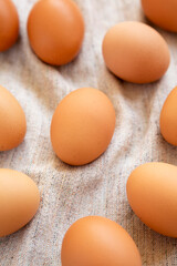 Raw Brown Eggs on cloth, low angle view.
