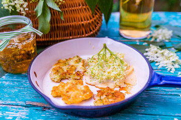 Homemade delicious fritters with elderberry flowers.