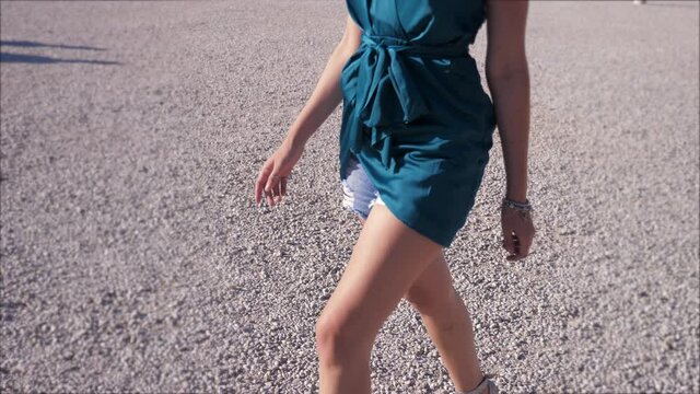 legs of beautiful woman wearing shorts walking at the park 