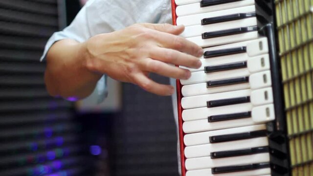 a man plays an accordion