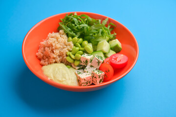 Fresh and organic vegetable salad with raw veggies - tomatoes, cucumbers, seeds and feta cheese.
