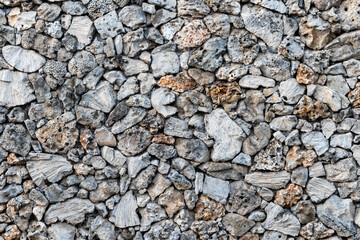 Textured stone wall, built with pieces of native marine sponge. Near Sanur beach, Bali, Indonesia.
