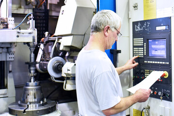 cnc machine in modern industrial mechanical engineering - workers at the workplace