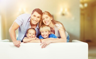 Fototapeta na wymiar Beautiful smiling family in a room on couch