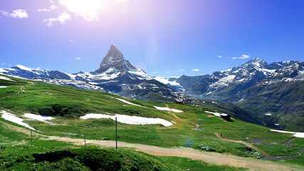 scenic photography panorama view Matterhorn peak with green field at the front on summer in Zermatt Switzerland
