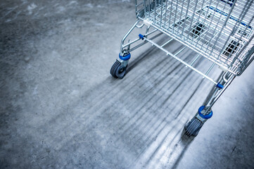 Empty shopping cart or shopping trolley in on concrete floor in supermarket or grocery store. Buying concept © zephyr_p