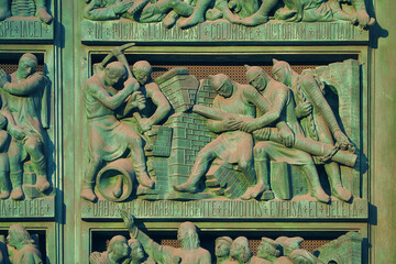 ancient old green color worker statue on the Milan Cathedral's facade in Milan city Italy