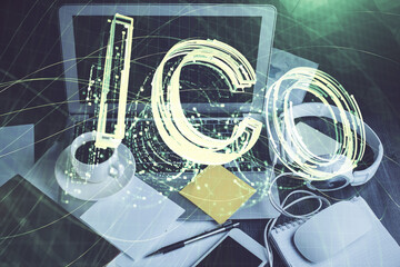 Multi exposure of blockchain and crypto economy theme hologram and table with computer background....