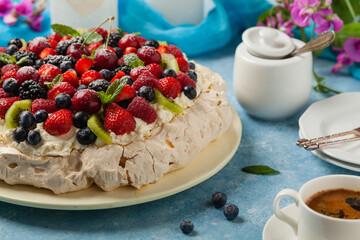 Meringue Pavlova cake with fresh fruit. Front view.
