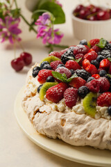 Meringue Pavlova cake with fresh fruit. Front view.