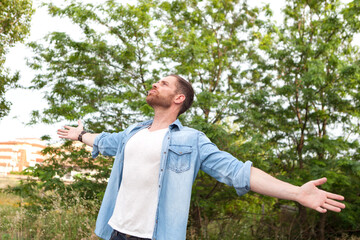 Carefree and free man raising his arms