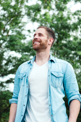 Casual guy with a denim shirt in a park