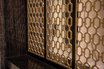Close-up of a golden design  fence. room partition.