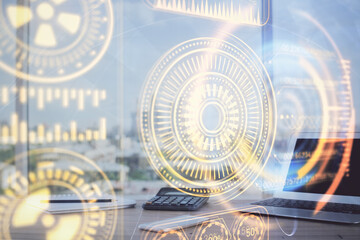 Fototapeta premium Computer on desktop in office with technology theme hologram. Multi exposure. Tech concept.