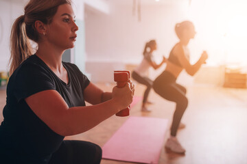 Beautiful young girls do fitness on mats, relax, care about health