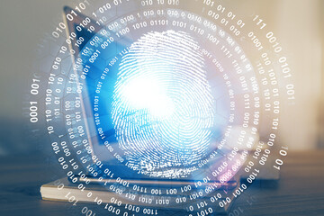 Computer on desktop in office with finger print drawing. Double exposure. Concept of business data security.