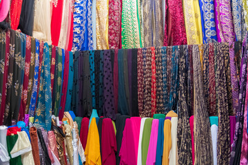 Rolls of fabric and textiles in a factory shop. Multi different colors and patterns on the market Fabrics in rolls. Fabric store